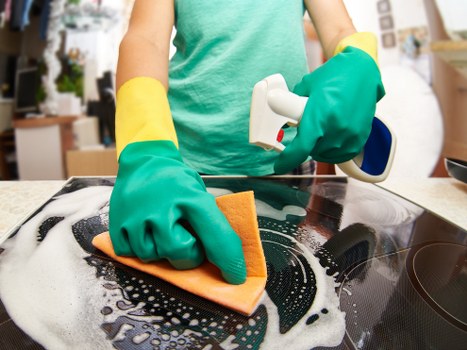 Technician carrying out detailed surface cleaning in a property interior